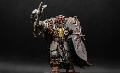 a painted warhammer with a sword and shield